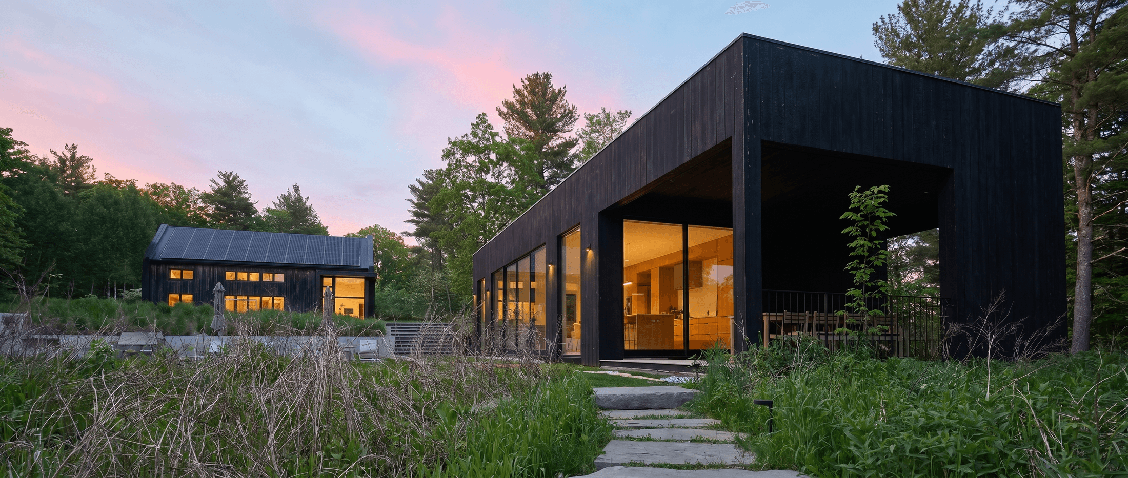 Black-wood pavilion and covered porch at dusk